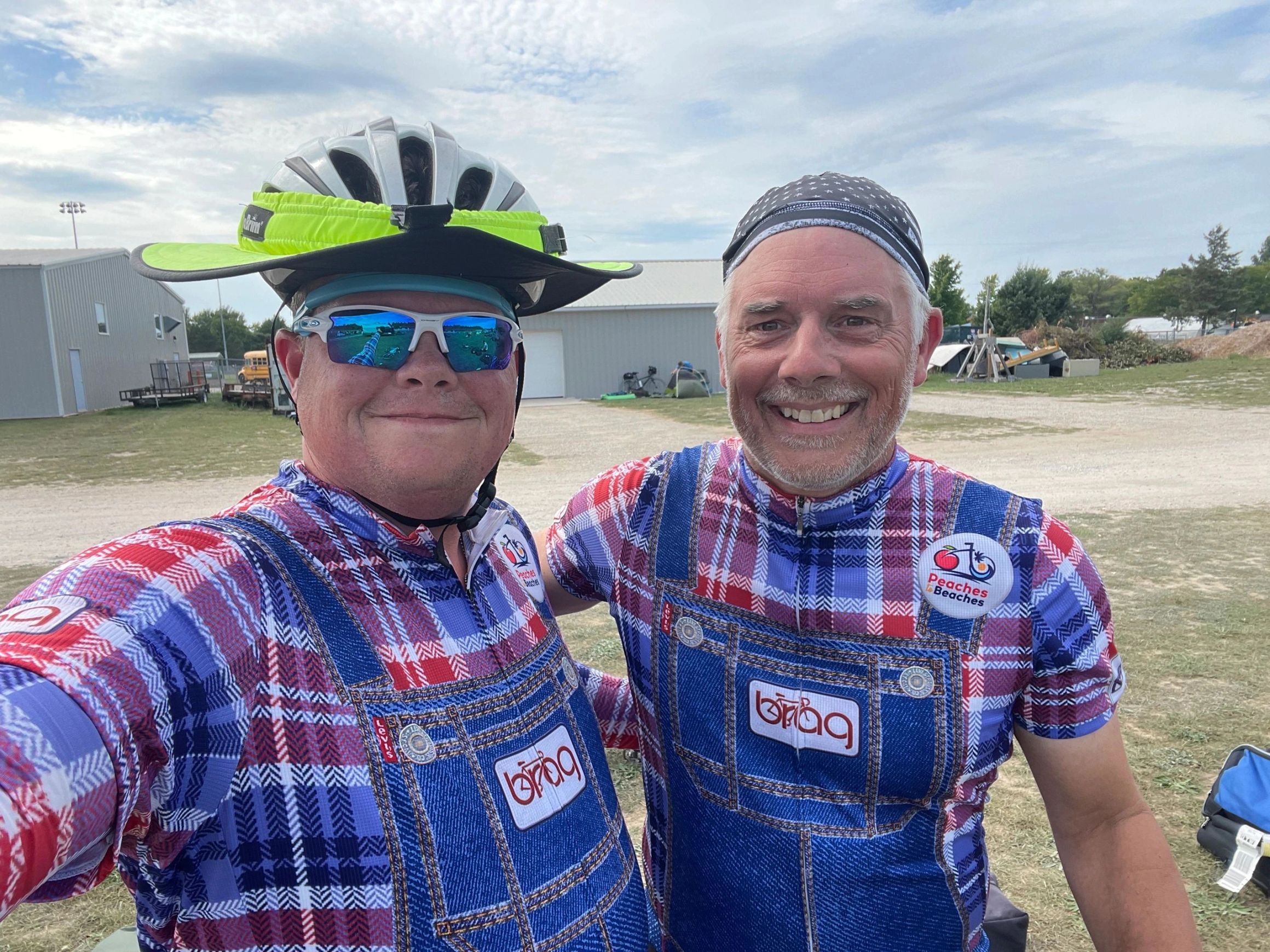 Two riders in BRAG denim-overall print jerseys