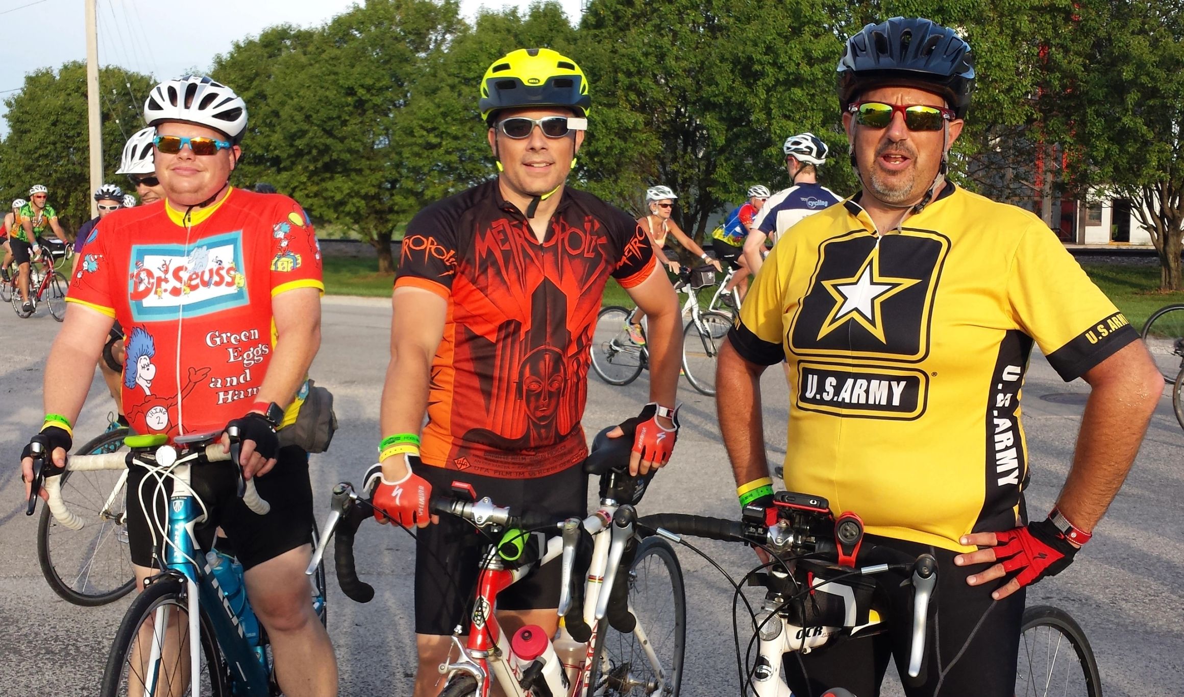 Three riders in costume jerseys at the start